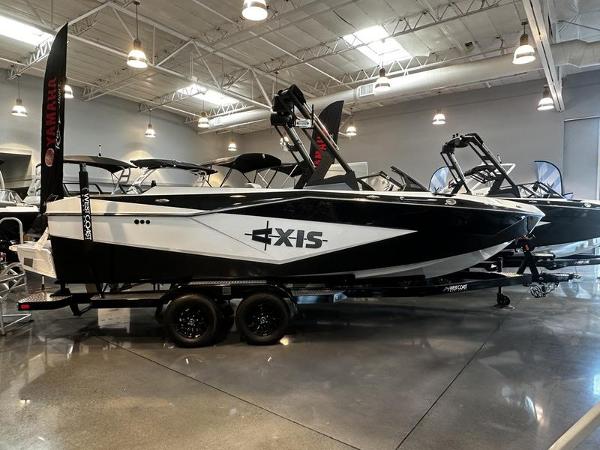 Axis T235 2025 Axis T235 boat displayed in a showroom, featuring sleek black and white design.