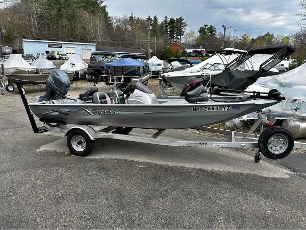 Xpress XP7 2018 Xpress XP7 boat on trailer, parked in a lot with other boats.