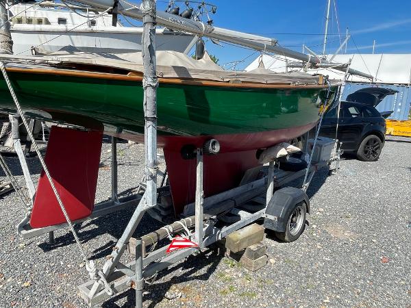 One Design Safe Harbour 12 Green and red 2010 One Design Safe Harbour 12 sailboat on trailer in a boatyard.