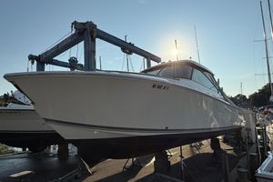 Pursuit DC 325 Dual Console 2019 Pursuit DC 325 Dual Console boat on dry dock under a clear sky.