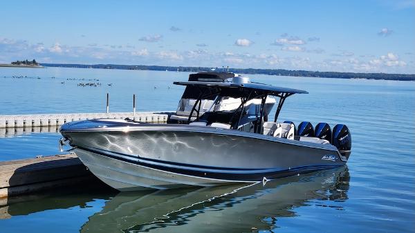 Nor-Tech 390 Sport 2022 Nor-Tech 390 Sport boat docked on a serene lake.