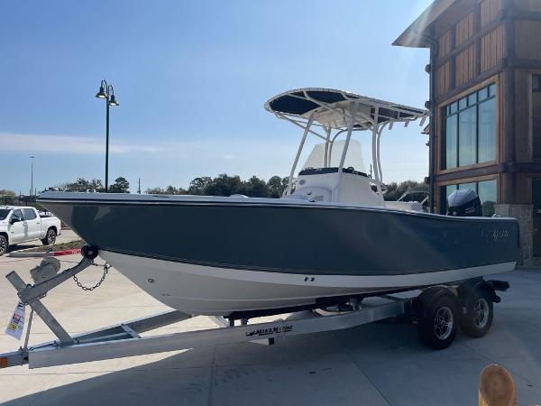 Mako 214 CC 2024 Mako 214 CC boat on trailer, parked outdoors near a building.