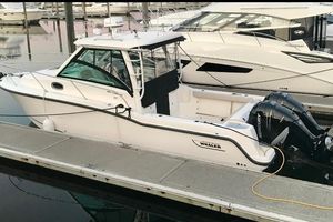 Boston Whaler 285 Conquest 2016 Boston Whaler 285 Conquest boat docked at marina with twin Mercury engines.