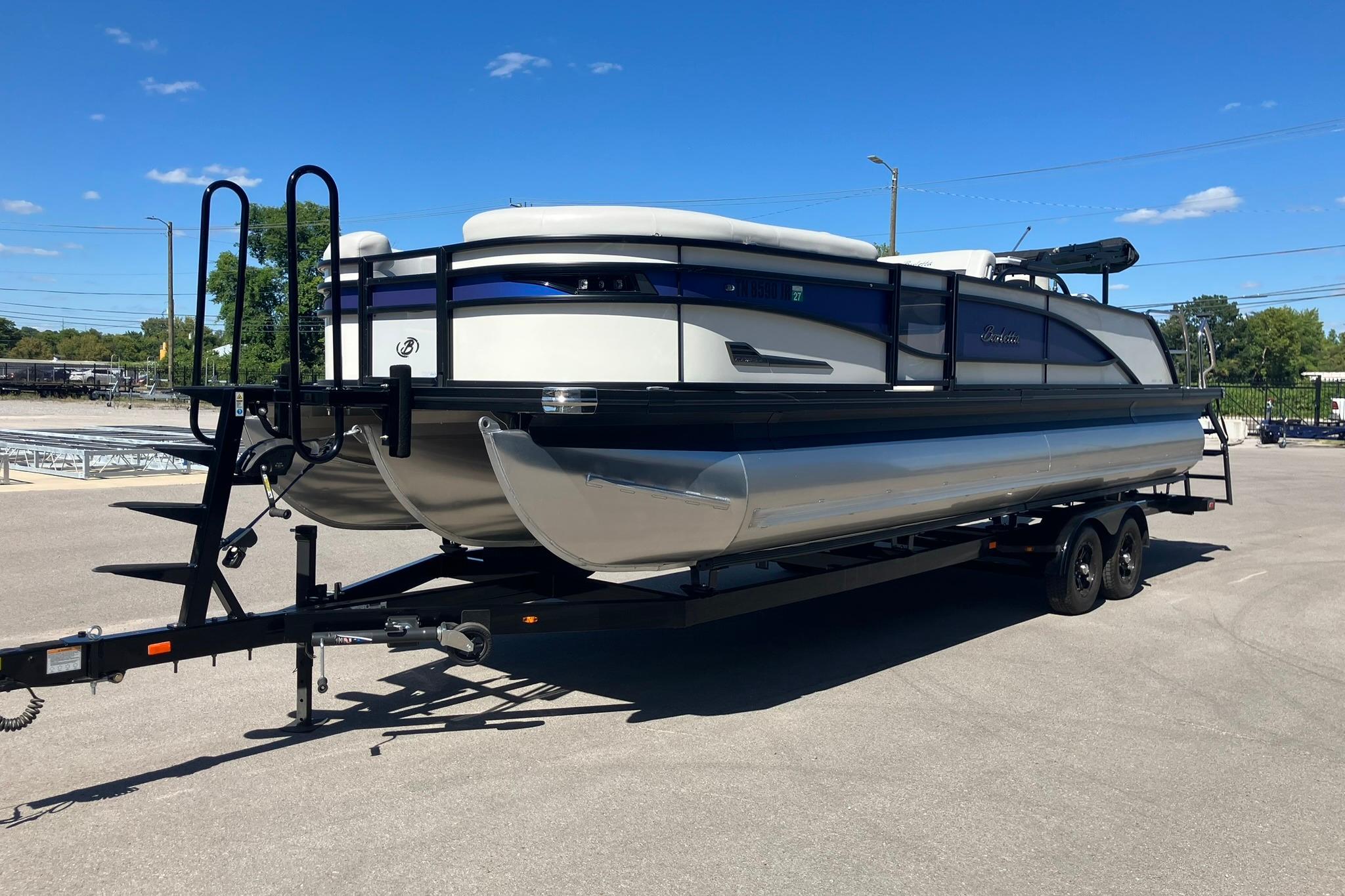 Barletta CORSA 25UE 2023 Barletta CORSA 25UE pontoon boat on trailer under clear blue sky.