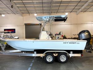 Key West 210 Bay Reef 2025 Key West 210 Bay Reef boat on trailer in indoor showroom.