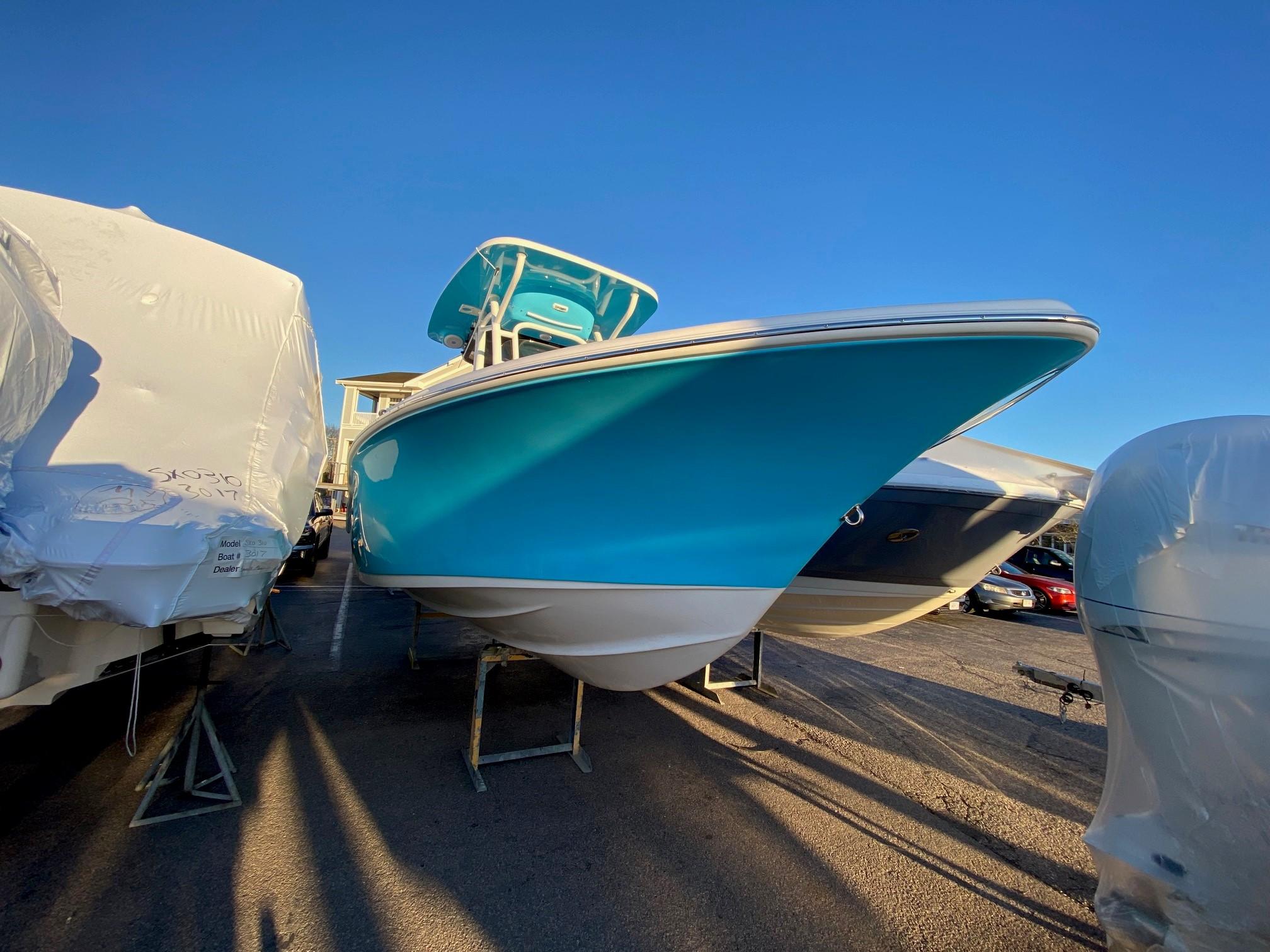 Key West 219 FS 2025 Key West 219 FS boat in vibrant blue, displayed outdoors under clear sky.