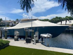 Grady-White Canyon 376 2021 Grady-White Canyon 376 boat covered at dockside, surrounded by palm trees and waterfront homes.