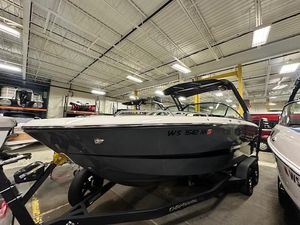 Chaparral 247 SSX 2022 Chaparral 247 SSX boat in showroom, sleek design, black hull, on trailer.