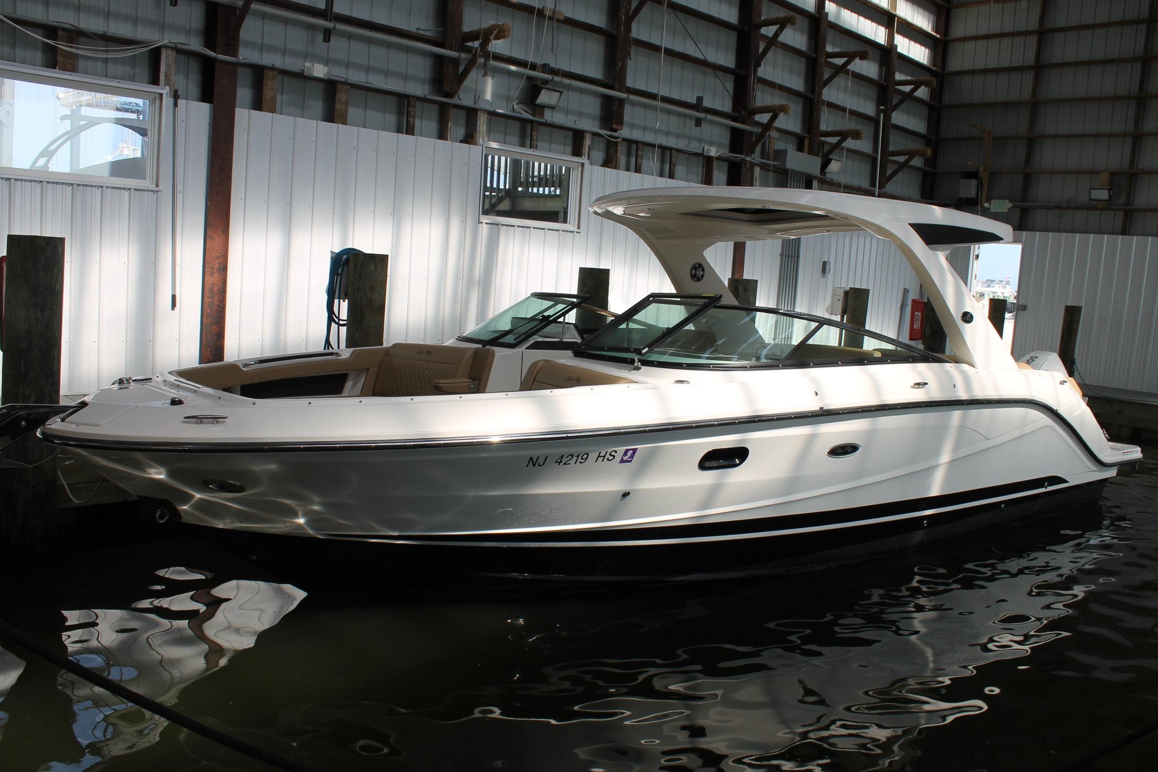 Sea Ray SLX 310 Outboard 2023 Sea Ray SLX 310 Outboard boat docked in a marina.