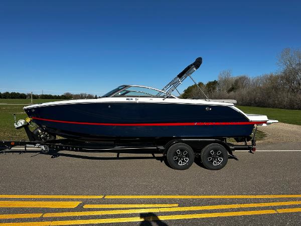 Four Winns H2 2023 Four Winns H2 boat on a trailer, side view.