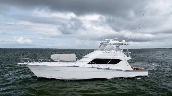 Hatteras 60 Convertible 2003 Hatteras 60 Convertible yacht on open water under cloudy sky.