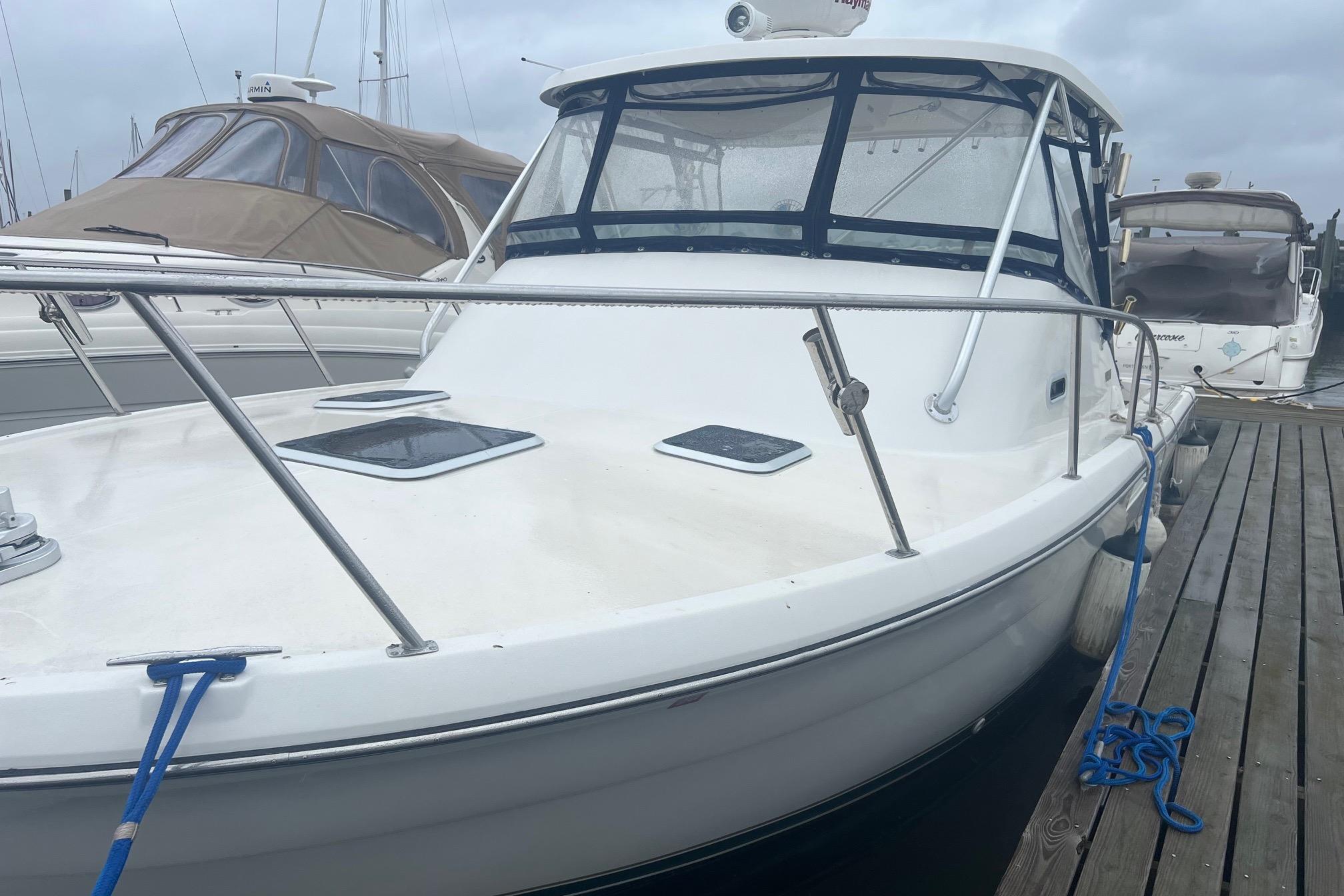 Pursuit 3000 Offshore 2001 Pursuit 3000 Offshore boat docked at marina, featuring sleek design and spacious deck.