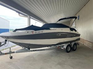 Hurricane SunDeck 2200 DC OB 2022 Hurricane SunDeck 2200 DC OB boat on trailer under a metal roof.
