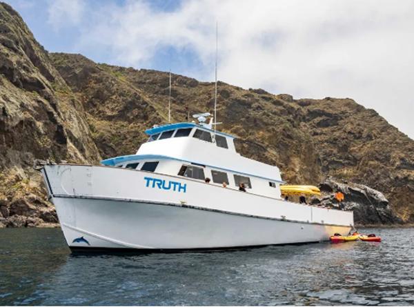 Custom Expedition Liveaboard Custom 1974 Expedition Liveaboard boat named "Truth" near rocky coastline.
