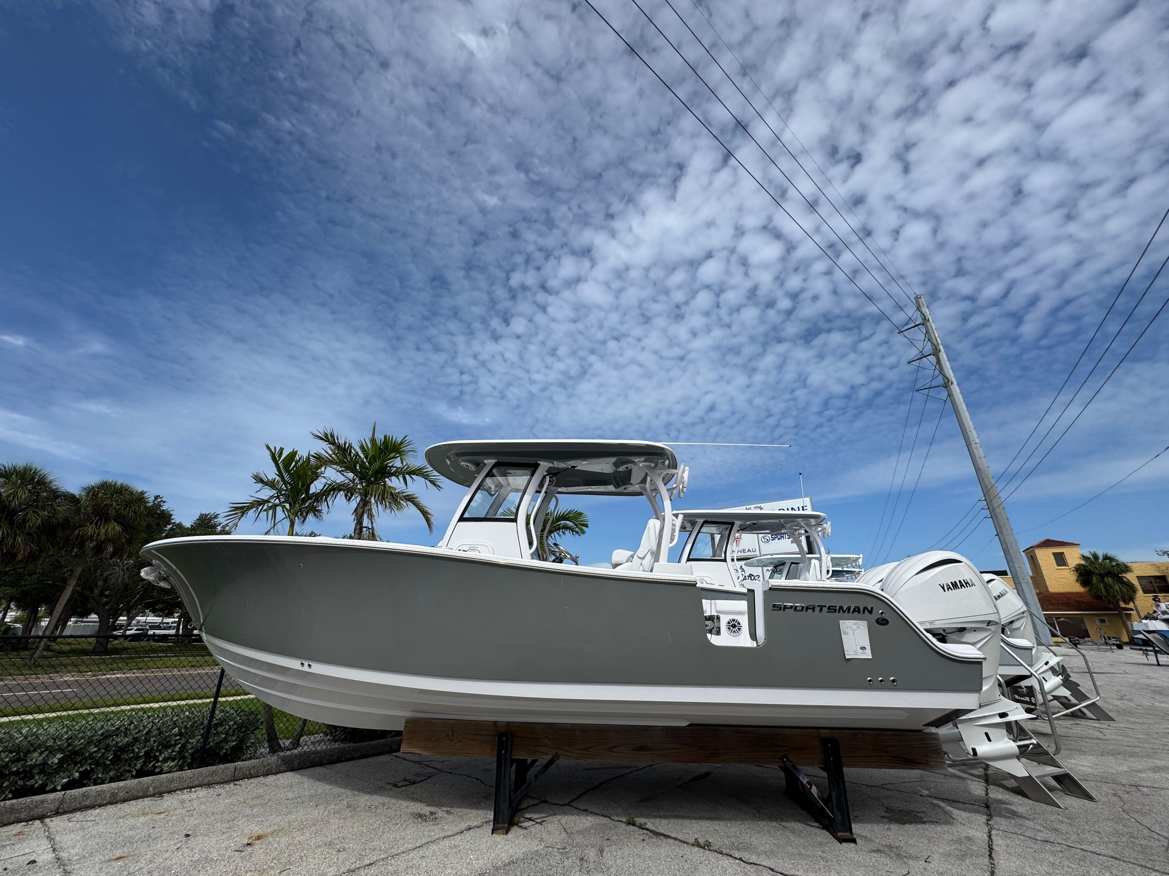Sportsman 282 Open 2025 Sportsman 282 Open boat displayed outdoors under a partly cloudy sky.