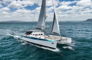 Outremer 55 STANDARD Outremer 55 STANDARD catamaran sailing on open sea, 2002 model, under clear skies.