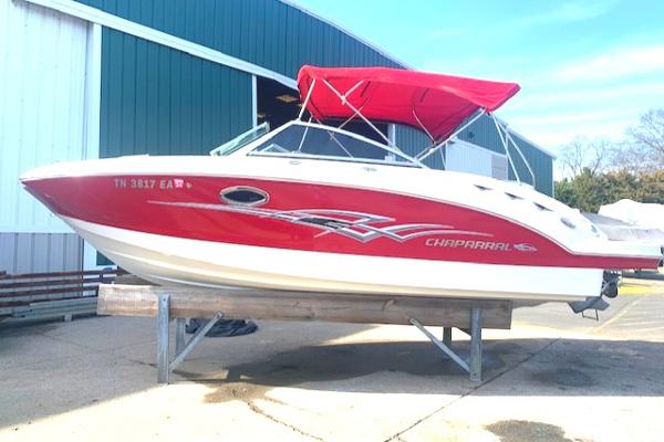 Chaparral Sunesta 224 2010 Chaparral Sunesta 224 boat with red and white design, docked outdoors.