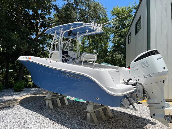 Aquasport 2300 Center Console 2022 Aquasport 2300 Center Console boat with Suzuki engine, displayed outdoors.