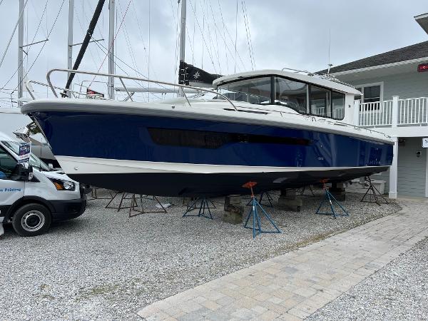 Nimbus C11 2024 Nimbus C11 boat on stands in a marina setting.