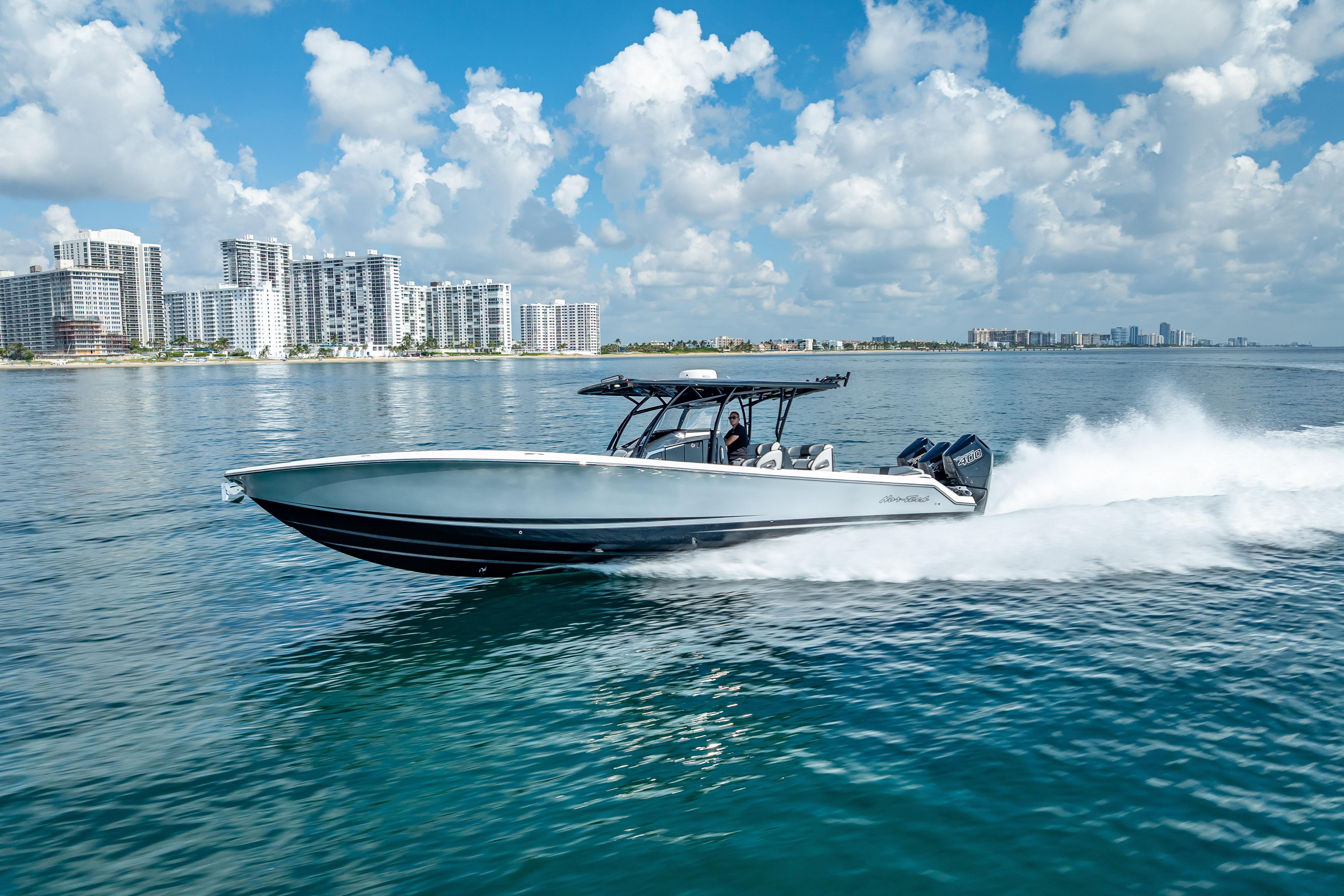 Nor-Tech 390 Sport Center Console 2024 Nor-Tech 390 Sport Center Console cruising on water with city skyline backdrop.