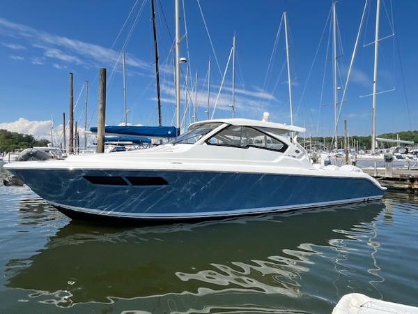 Pursuit DC 365 Dual Console 2019 Pursuit DC 365 Dual Console boat docked in marina under clear blue sky.