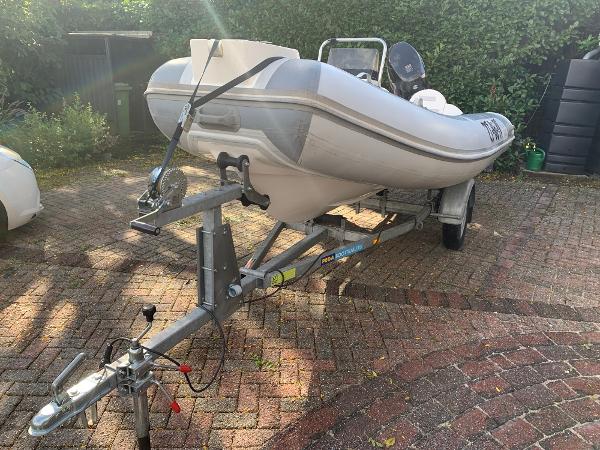 Nimarine RMX410 2016 Nimarine RMX410 inflatable boat on trailer in driveway.