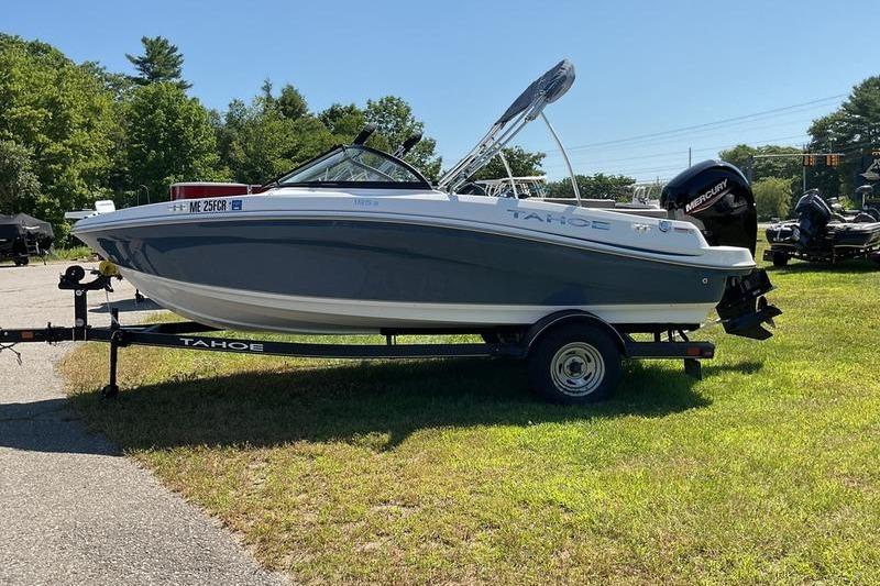 Tahoe 185 S 2023 Tahoe 185 S boat on trailer, parked on grass, with outboard motor.