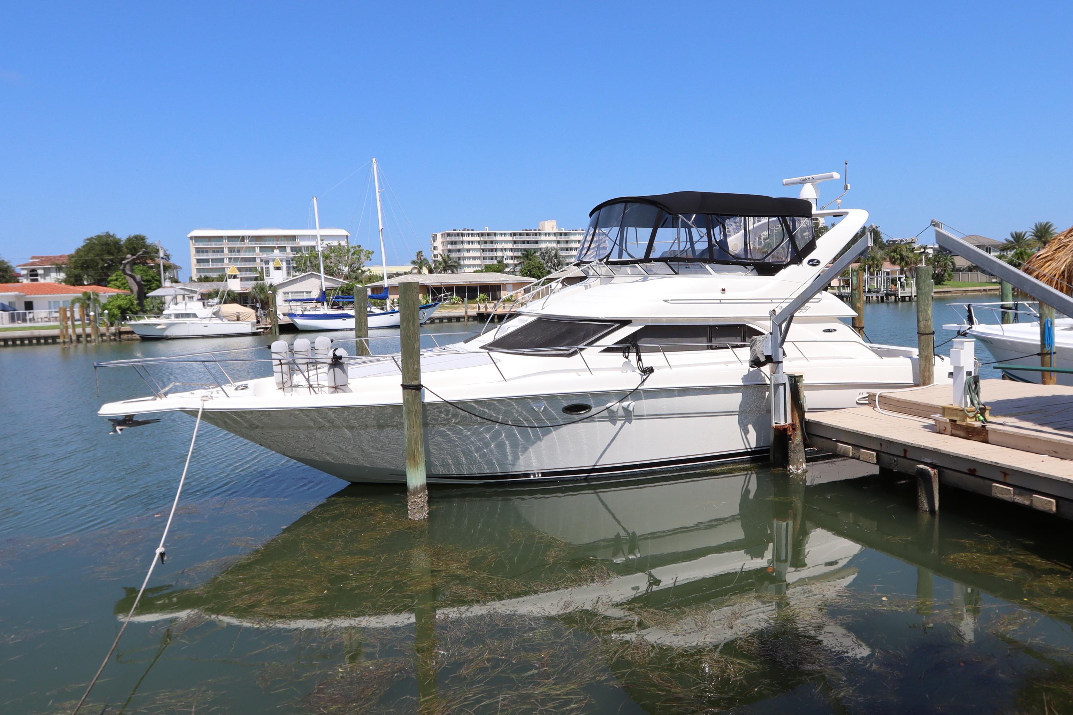 Sea Ray 450 Express Bridge 2003 Sea Ray 450 Express Bridge yacht docked in a marina under clear blue skies.
