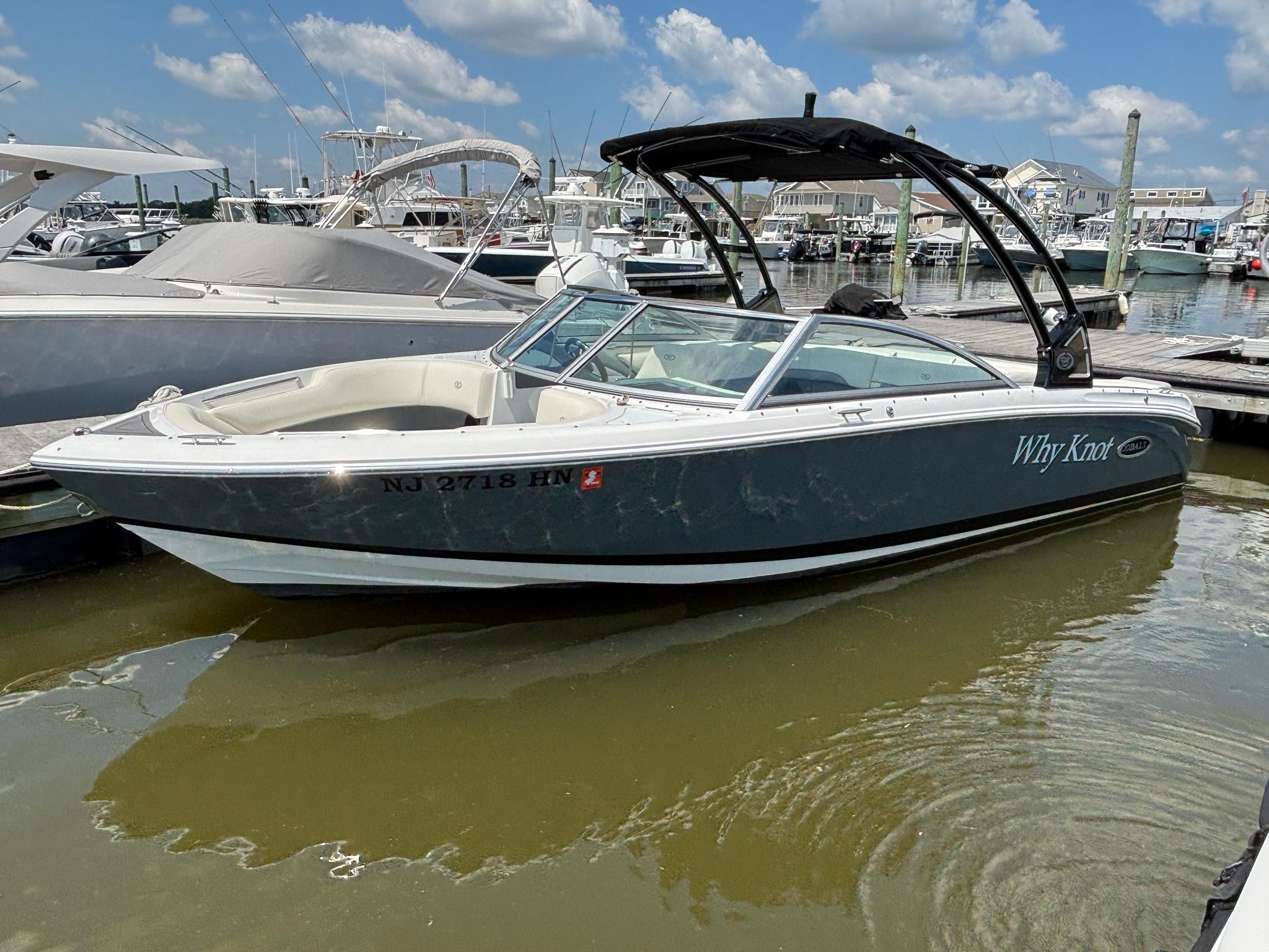 Cobalt 220S 2019 Cobalt 220S boat docked at marina under blue sky.