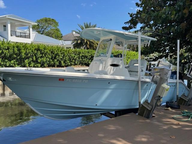 Cobia 240 Center Console 2022 Cobia 240 Center Console boat docked by waterfront home.