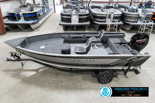 Lund 1775 Pro Guide 2025 Lund 1775 Pro Guide fishing boat in showroom, featuring Mercury outboard motor.