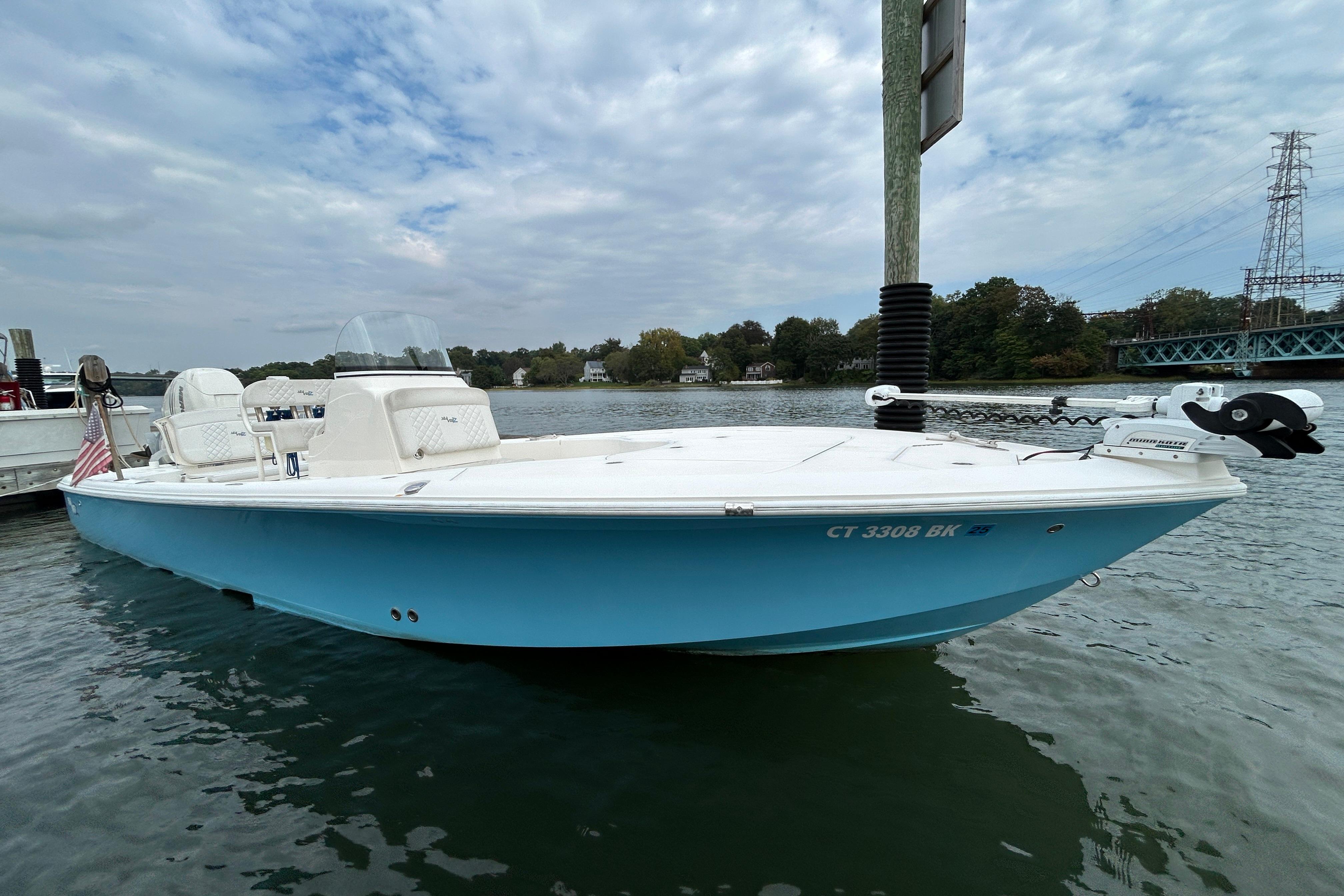 SeaVee 270Z 2018 SeaVee 270Z boat docked on calm water under cloudy sky.