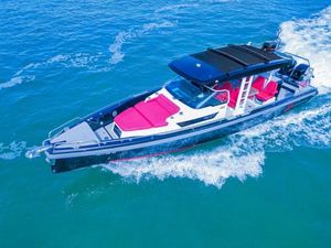 Axopar 37 Sun Top 2018 Axopar 37 Sun Top boat cruising on blue water with red seating.
