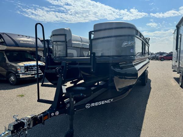 Regency 250 DL3 2023 Regency 250 DL3 pontoon boat on trailer under a clear blue sky.