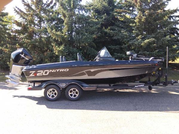 Nitro ZV20 Pro 2024 Nitro ZV20 Pro boat parked outdoors, side view with trees in background.