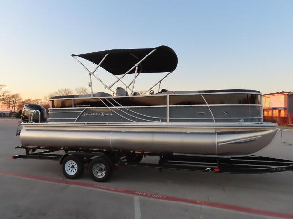 South Bay 224 RS 2.75 2024 South Bay 224 RS 2.75 pontoon boat on trailer, parked outdoors at sunset.