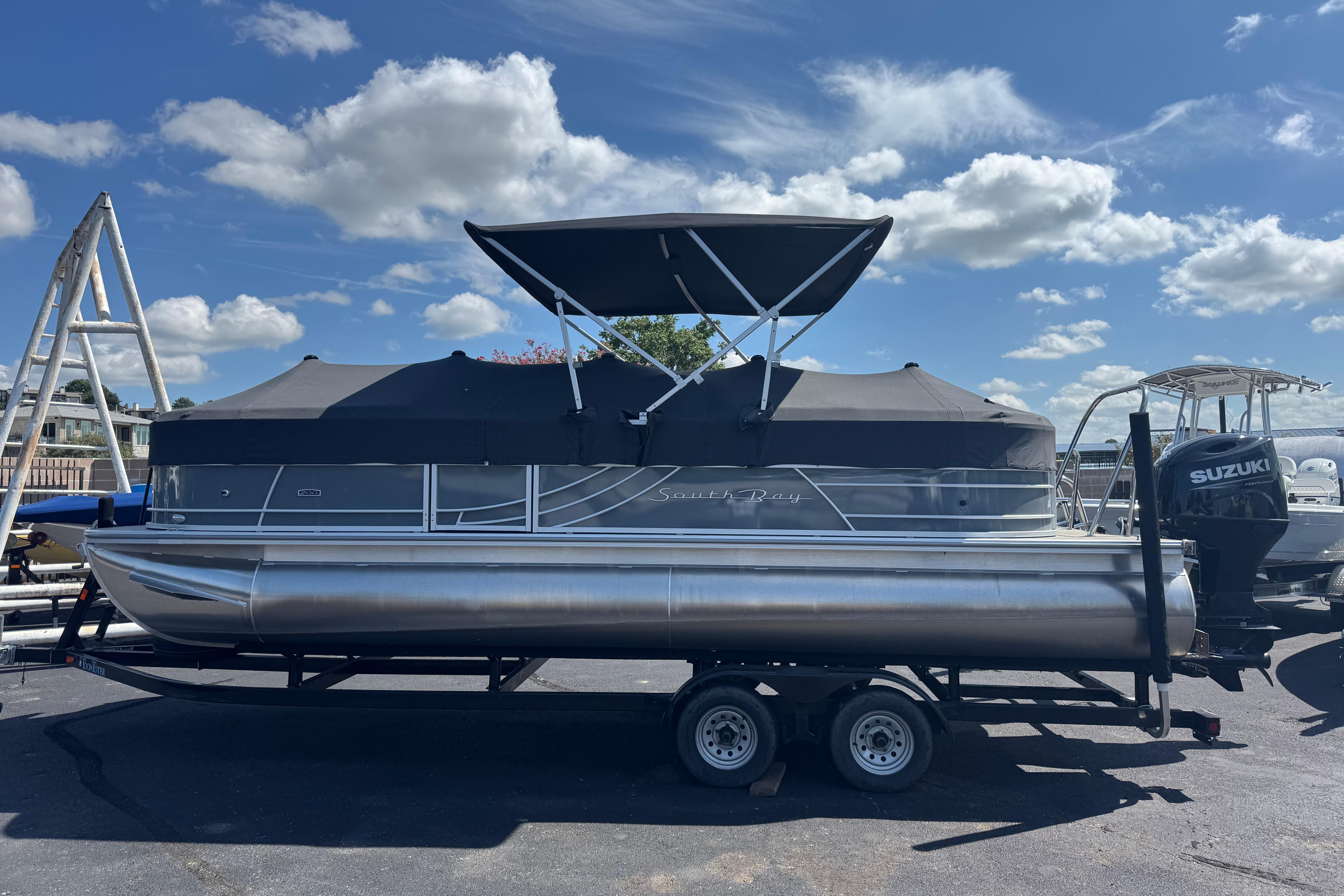 South Bay 224 RS 2.75 2024 South Bay 224 RS 2.75 pontoon boat with Suzuki engine on trailer.
