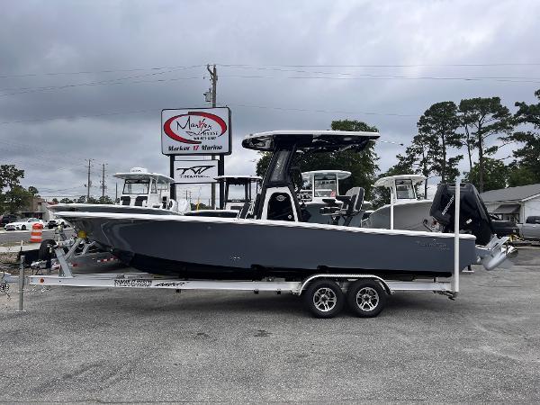Tidewater 2500 Carolina Bay 2025 Tidewater 2500 Carolina Bay boat on trailer at dealership, overcast sky.