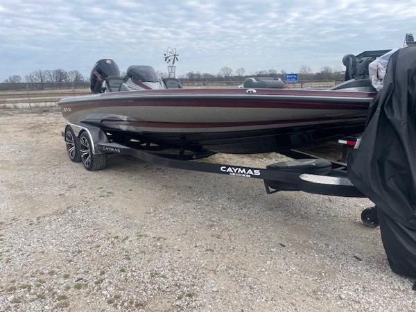 Caymas CX21 Pro 2023 Caymas CX21 Pro boat on trailer, parked on gravel lot.