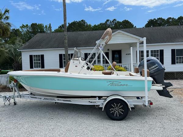 Pioneer 180 Islander 2025 Pioneer 180 Islander boat on trailer, parked in front of a house.