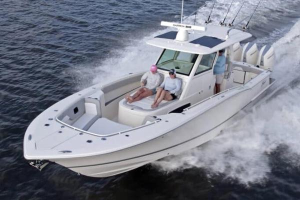 Scout 357 LXF Manufacturer Provided Image: 2025 Scout 357 LXF boat cruising on water with passengers enjoying the ride.