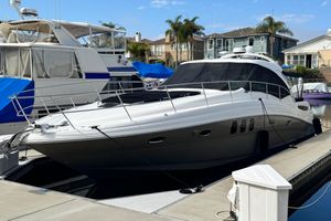 Sea Ray 48 Sundancer 2006 Sea Ray 48 Sundancer yacht docked at marina with nearby boats.