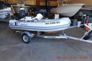 Highfield CL310 2024 Highfield CL310 inflatable boat on trailer in a garage setting.