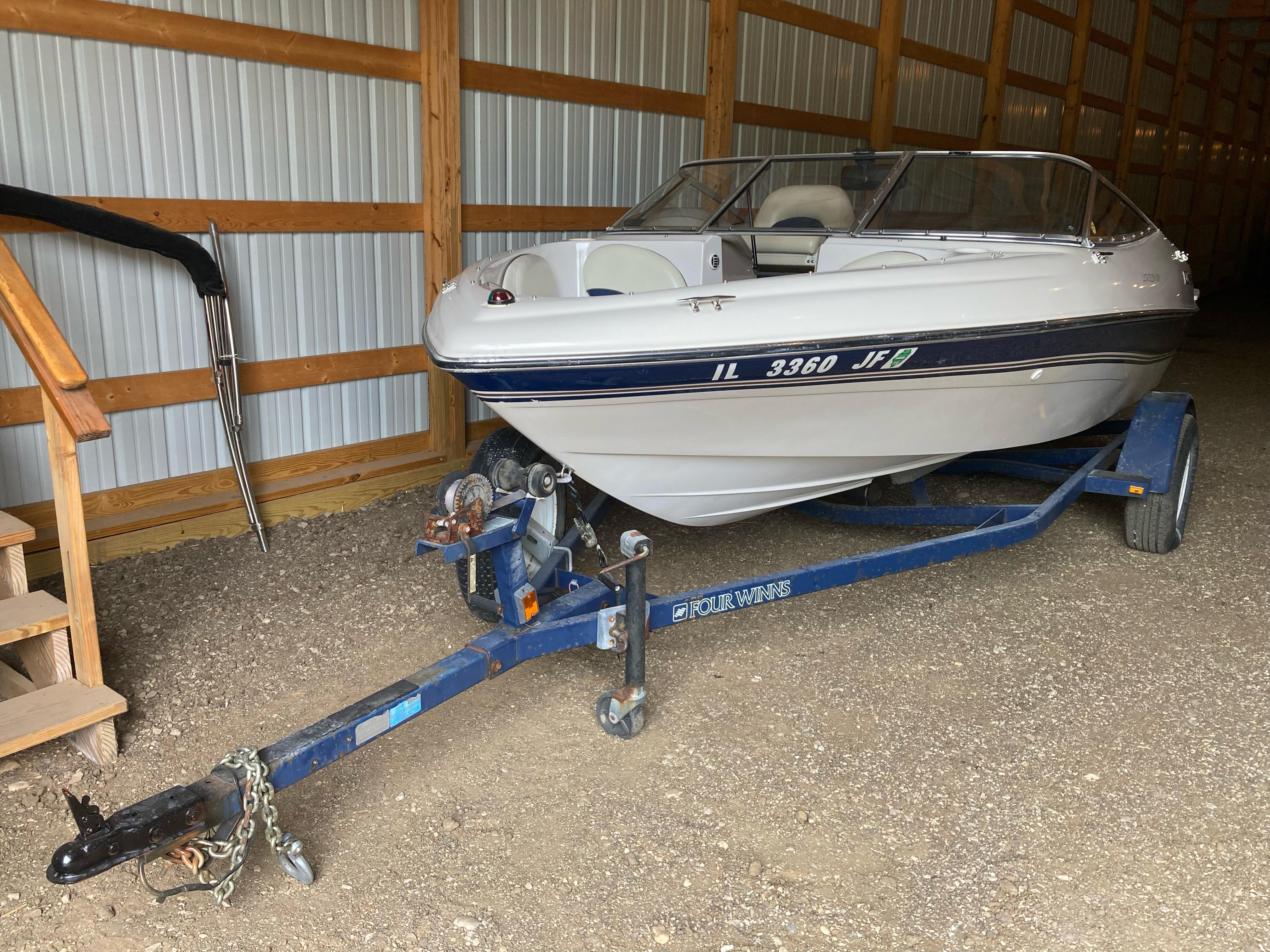 Four Winns Horizon QX 1998 Four Winns Horizon QX boat on trailer in storage shed.