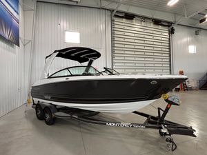 Monterey 238SS Luxury Bowrider 2025 Monterey 238SS Luxury Bowrider in showroom, black and white design on trailer.