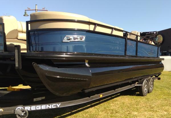 Regency 250 DL3 2024 Regency 250 DL3 pontoon boat on trailer, side view.