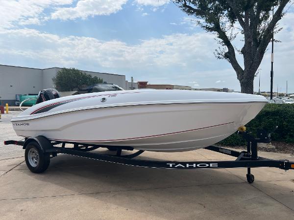 Tahoe T18 2024 Tahoe T18 boat on trailer, parked outdoors.
