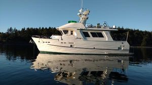 Bracewell latitude 47 Bracewell Bray yacht design Bracewell Latitude 47 yacht on calm water, reflecting trees and clear sky.