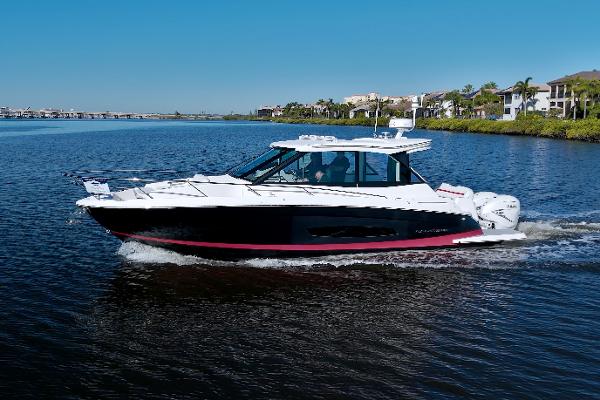 Regal 36 XO 2021 Regal 36 XO boat cruising on a calm lake under a clear blue sky.