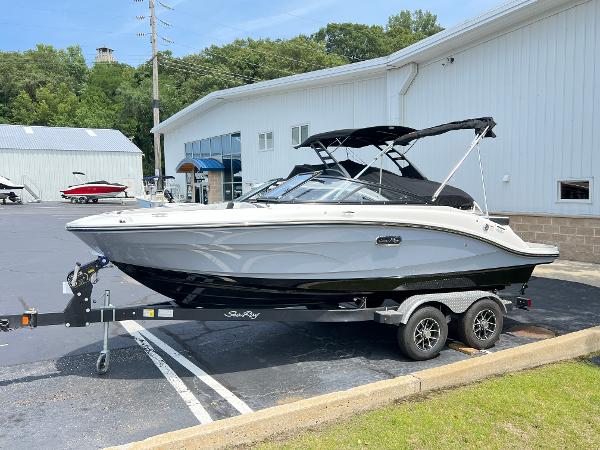 Sea Ray SPX 190 2025 Sea Ray SPX 190 boat on a trailer outside a white building.